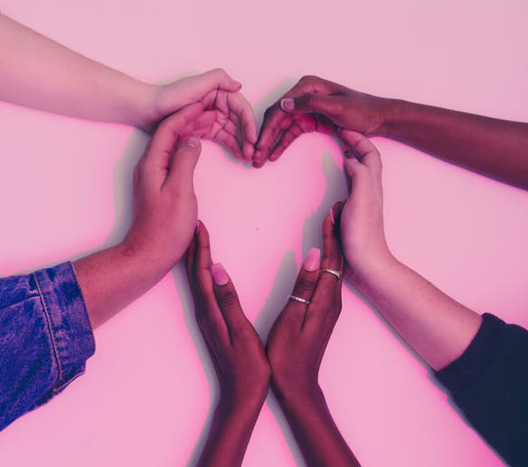 Joined hands forming a heart shape signifying that others’ stories connect you to their experiences.